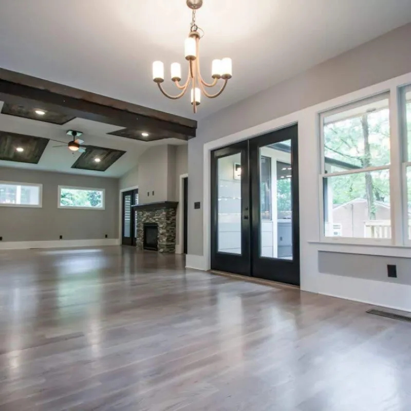 a large room with a wood floor and a fireplace