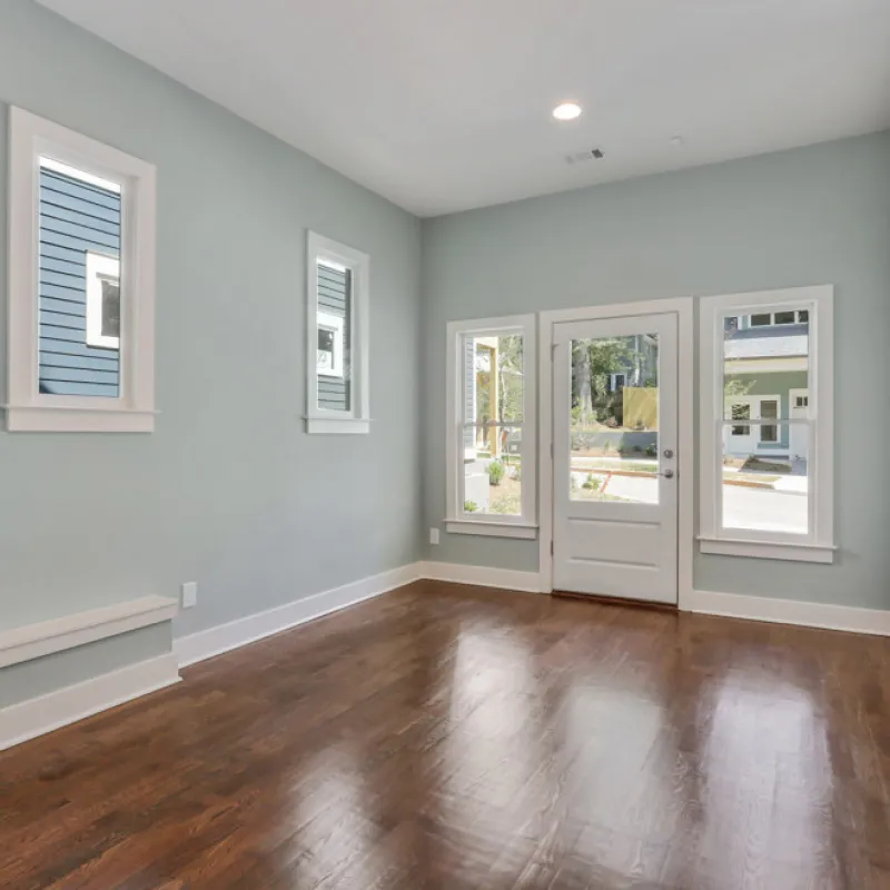 a room with white walls and windows