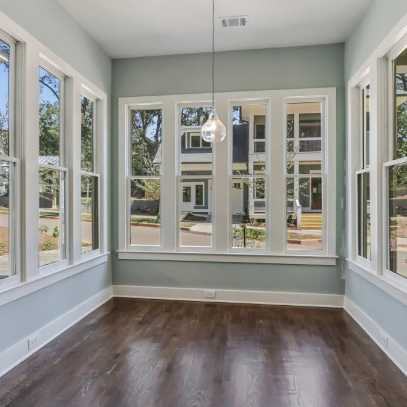 a room with windows and a wood floor