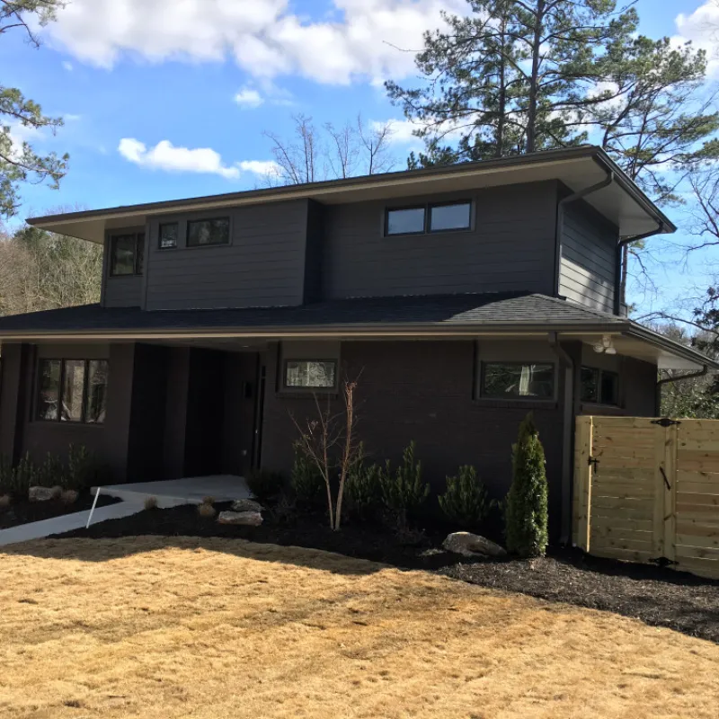 a house with a fence and trees