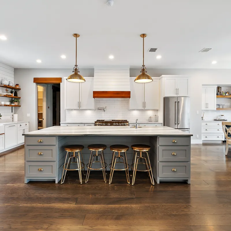 a kitchen with a bar stools and a table