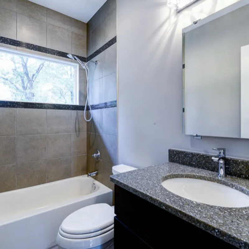 a bathroom with a tub sink and toilet
