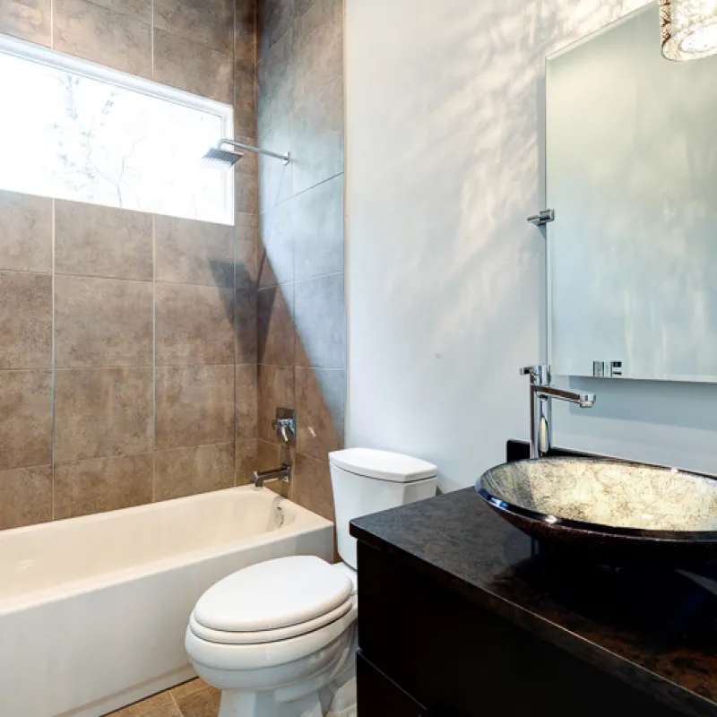 a bathroom with a tub and toilet