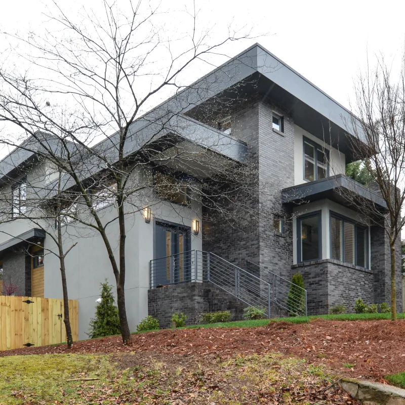 a house with a fence and trees