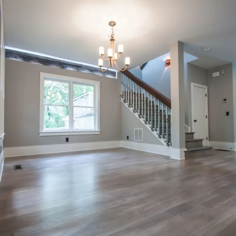 a large empty room with a wood floor and a wood floor