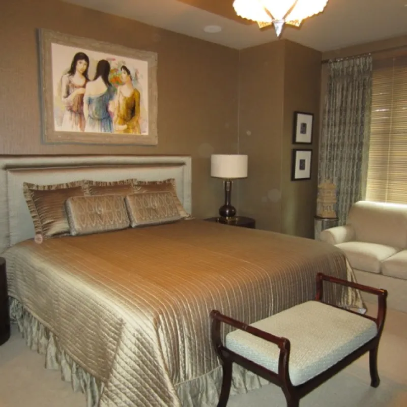 a bedroom with a bed and a chair