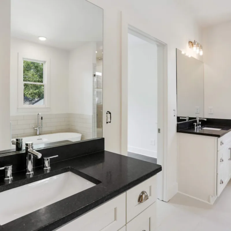 a bathroom with a large black countertop