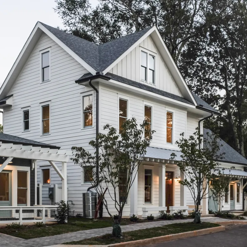 a white house with trees in the front