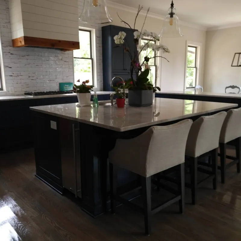 a kitchen with a bar and chairs