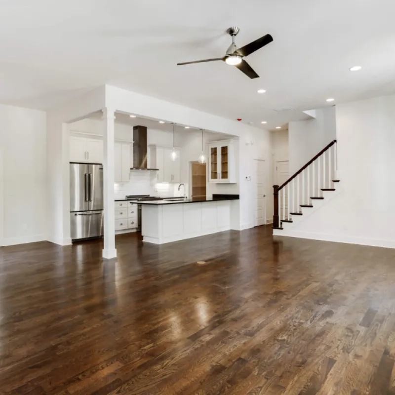 a large kitchen with a wood floor