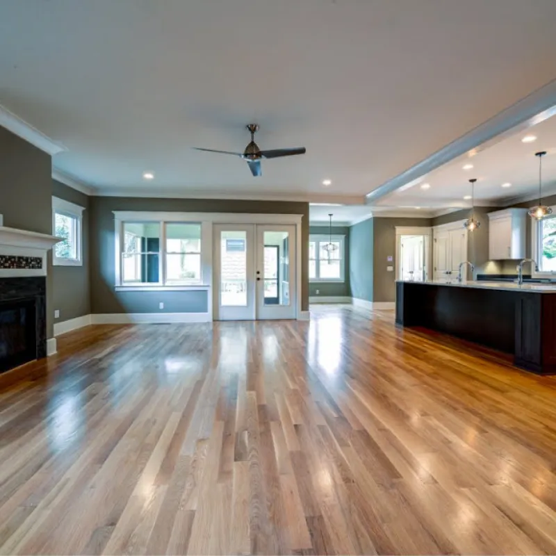 a large room with a wood floor and a fireplace