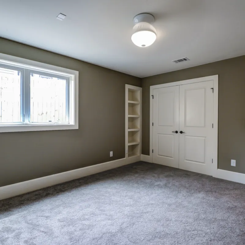 a room with white doors and a window