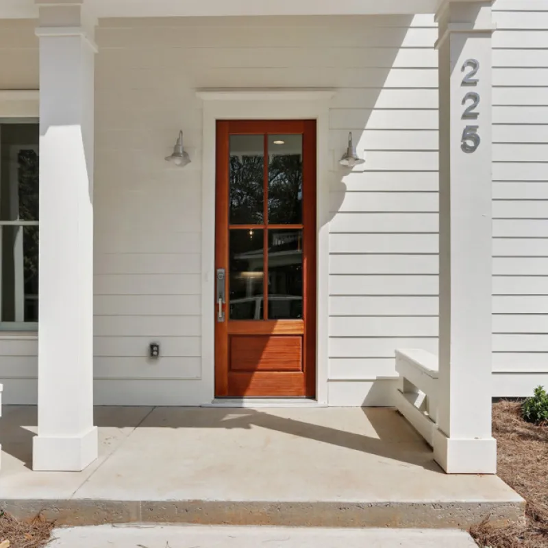 a white house with a door and pillars