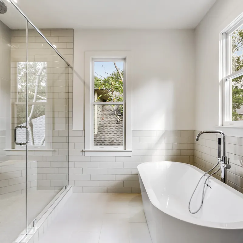 a bathroom with a bathtub and windows