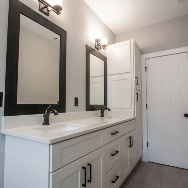 a bathroom with white cabinets