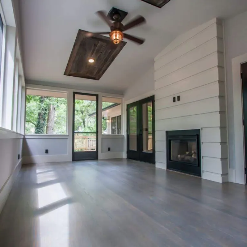 a room with a wood floor and a ceiling fan