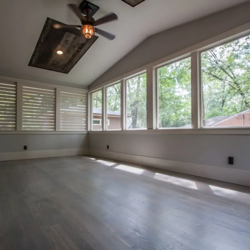 a room with a wood floor and a ceiling fan