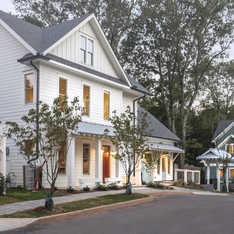 a white house with trees in the front