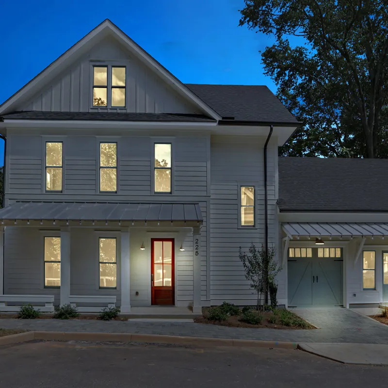 a grey house with a white fence