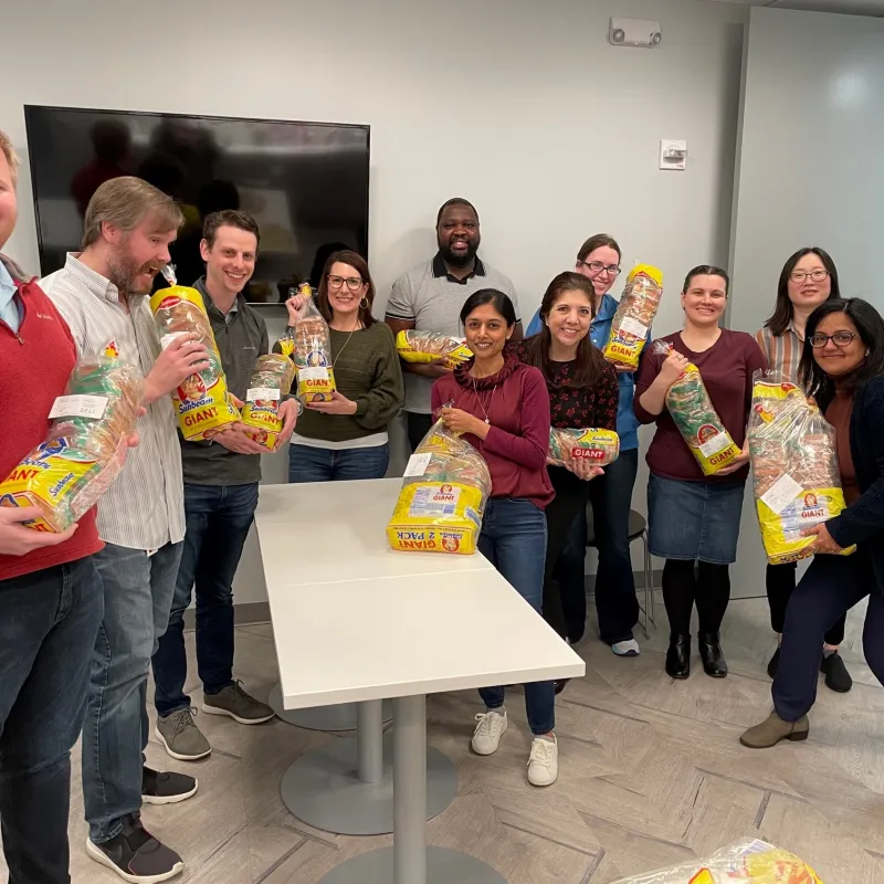 a group of people holding bags of food