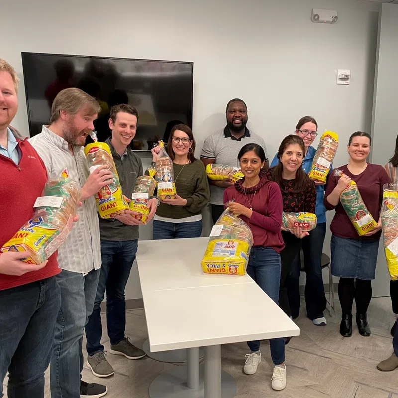 a group of people holding bags of food