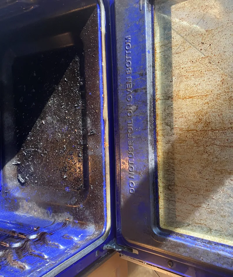 dirty oven filled with old food that needs to be cleaned