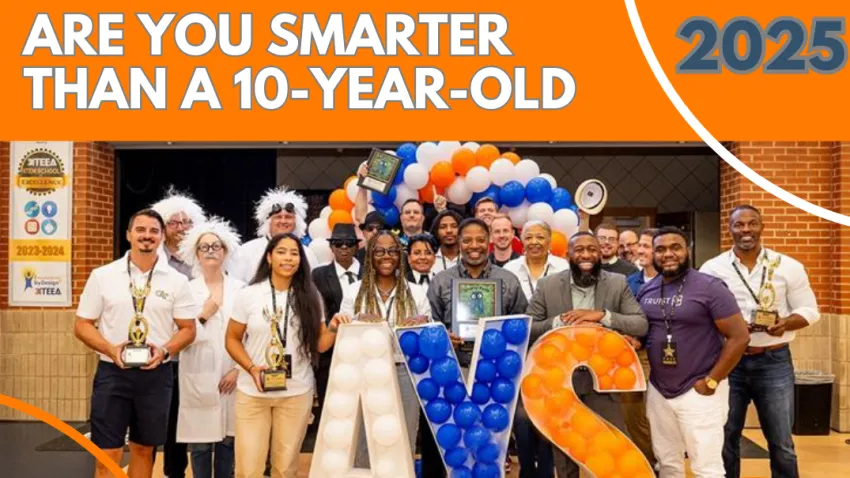 Group photo of diverse adults holding trophies and awards behind balloon letters A, Y, and S at event venue.