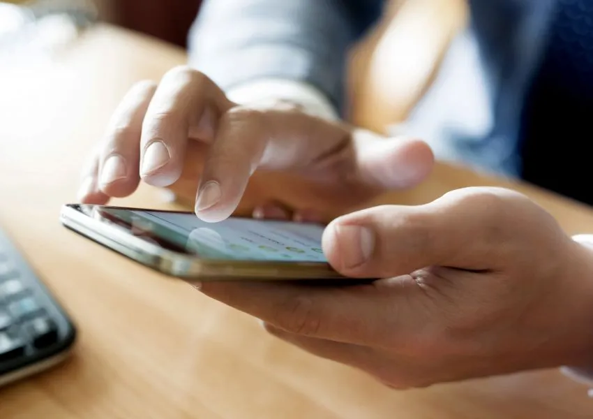 a hand holding a cell phone