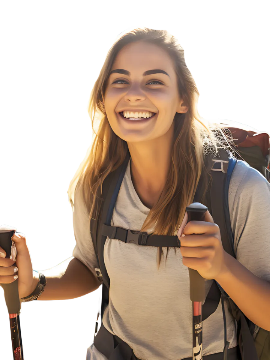 Smiling young woman hiking with backpack and trekking poles enjoying outdoor adventure.