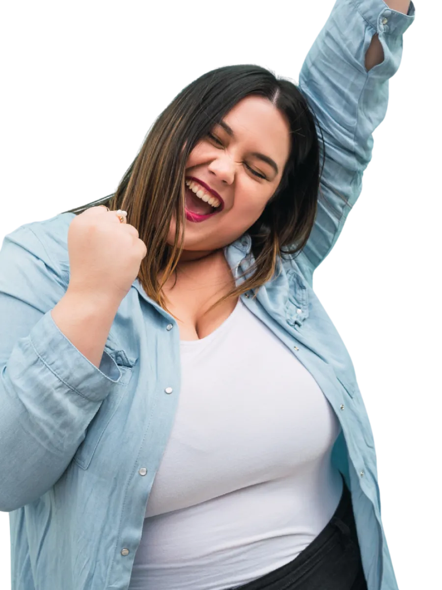 Happy plus-size woman in blue shirt and white top celebrating with raised fist and closed eyes