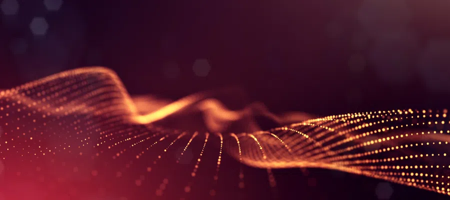 Abstract digital wave of glowing orange dots on dark purple background with smooth flowing curves.