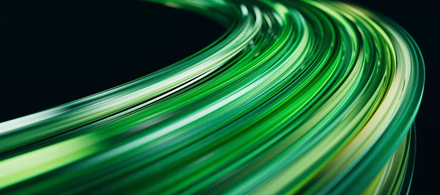 Abstract curved streaks of green light on a dark background creating a dynamic flowing motion effect.