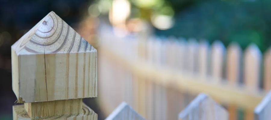 a wooden birdhouse on a fence