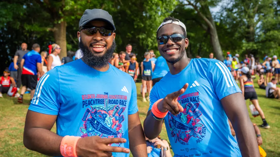 two men wearing matching shirts