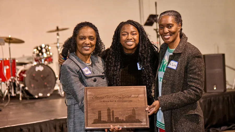 a group of people holding a plaque