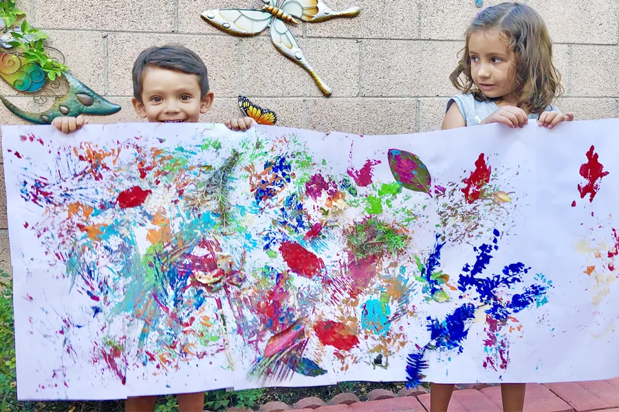 Boy and girl holding nature paint art