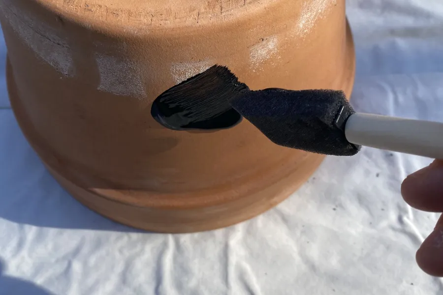 an image involving painting a pot