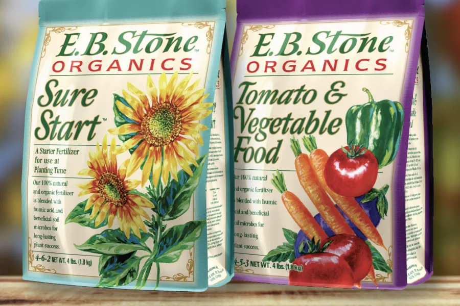 E.B. Stone organic fertilizers Sure Start and Tomato & Vegetable Food with vibrant plant illustrations on packaging.