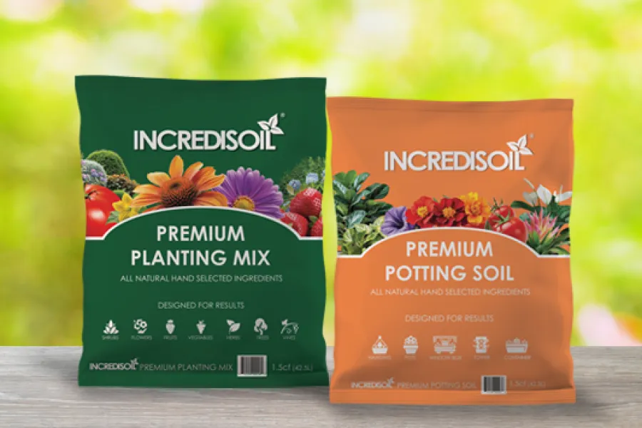 Two bags of IncrediSoil premium planting mix and potting soil with vibrant images of vegetables and flowers.