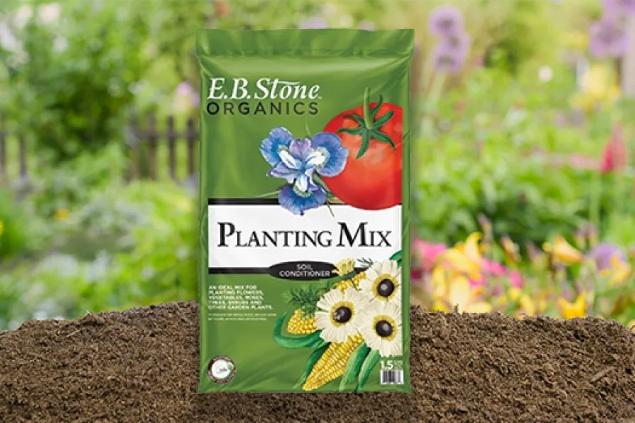 Bag of E.B. Stone Organics Planting Mix soil conditioner with vegetable and flower illustrations on soil mound.