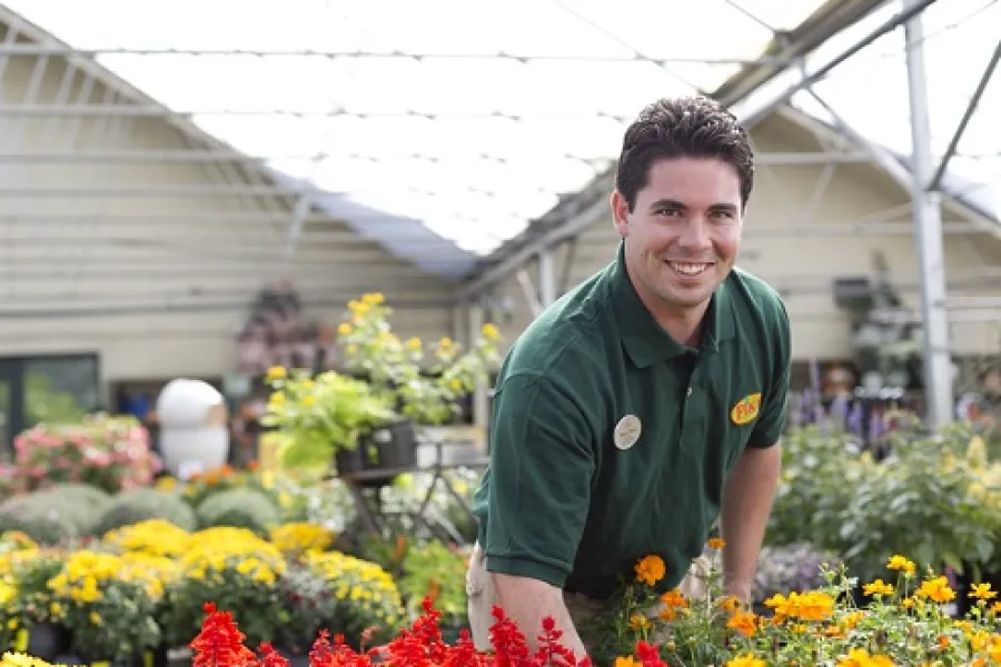 Male Pike associate in greenhouse with blooming plants