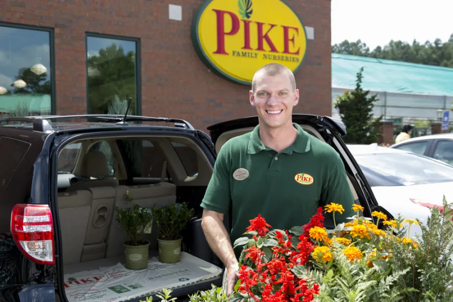 a person standing in front of a car