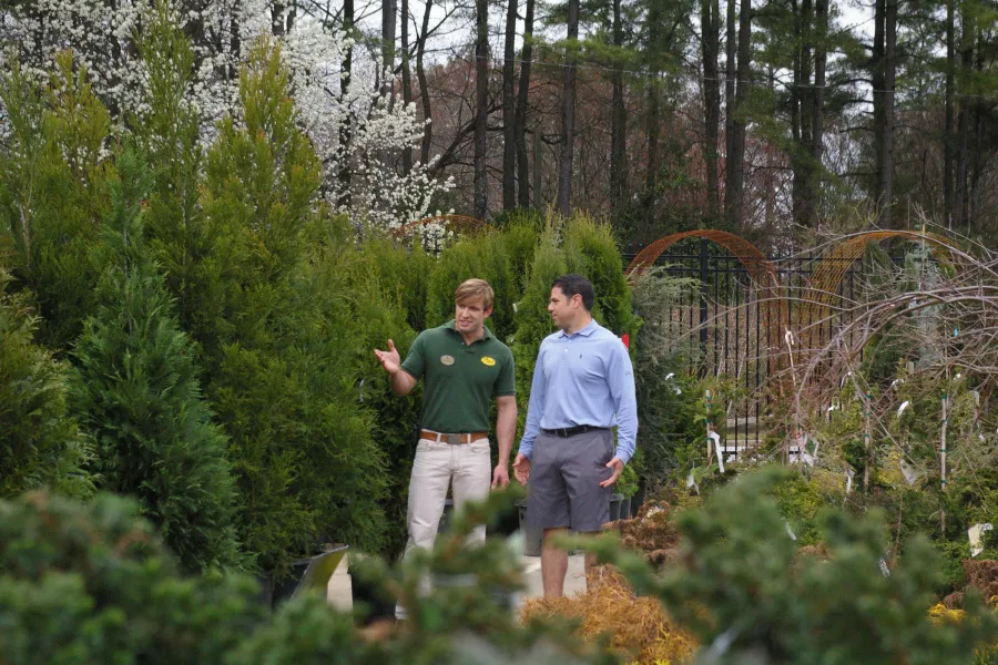 a man standing next to a tree