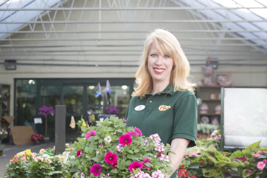 Pike associate holding blooming petunias