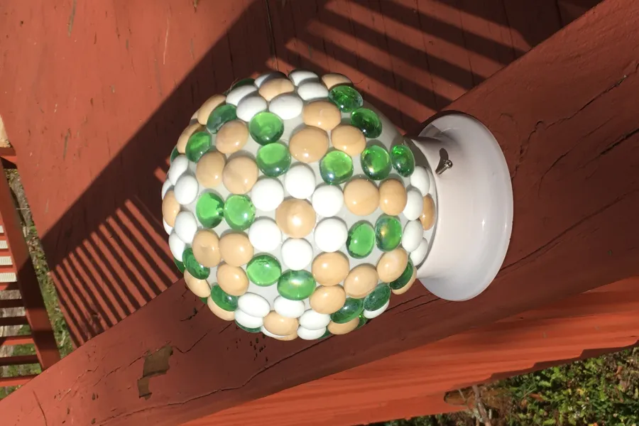 a garden globe sitting on a bench