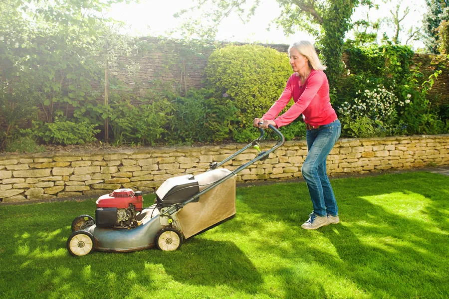 woman mowing grass
