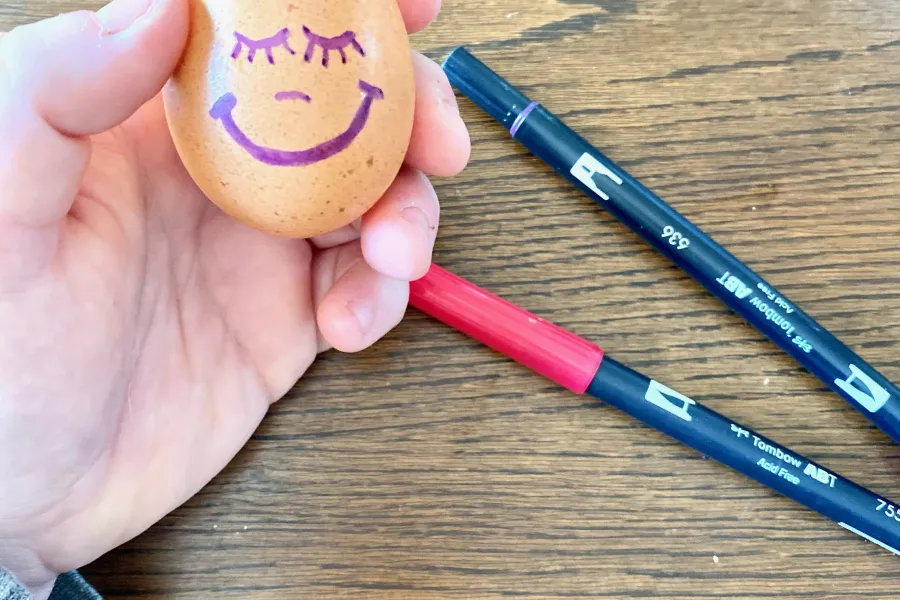 a wooden table egg head planter markers