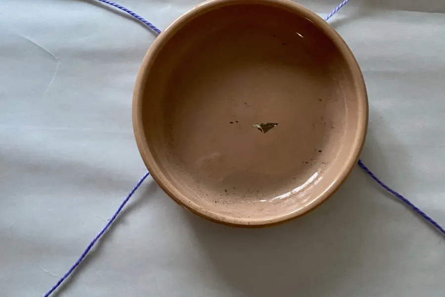 a saucer and string sitting on a table