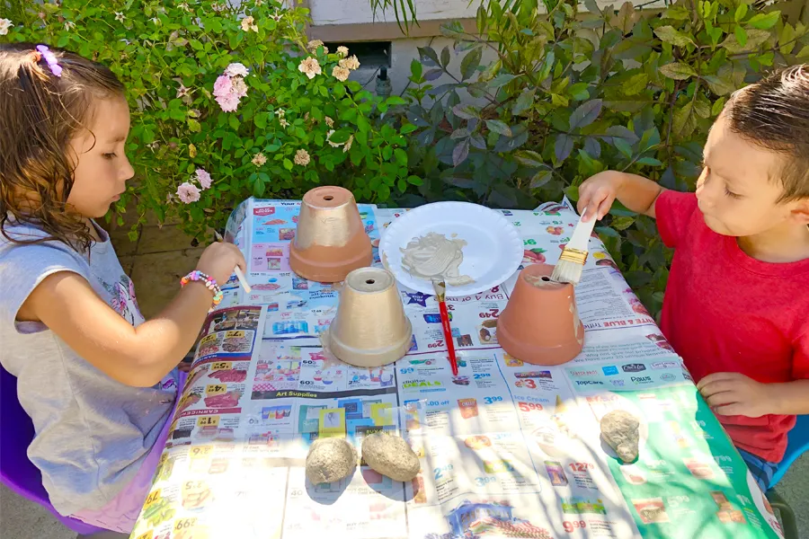 girl and boy with painting flower pots