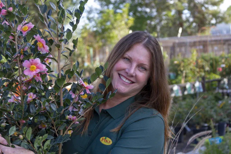 a person standing in a garden smiling